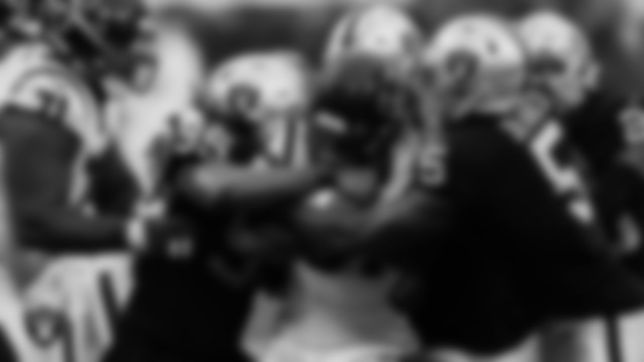 Las Vegas Raiders defensive end Kendal Vickers (95) and linebacker Divine Deablo (5) make a tackle during the regular season home game against the Houston Texans at Allegiant Stadium.