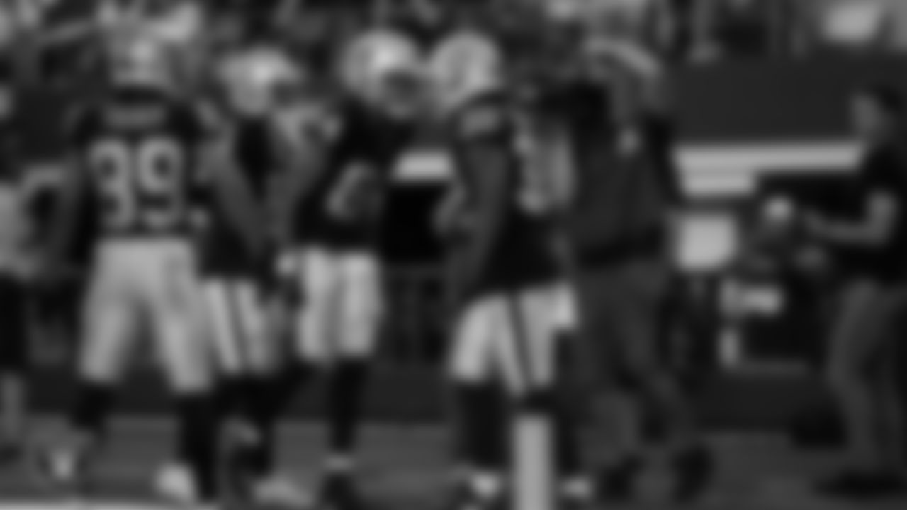 Las Vegas Raiders running back Damien Williams (32) celebrates with wide receiver Keelan Cole Sr. (84) after rushing for a 24-yard touchdown during the preseason away game against the Dallas Cowboys at AT&T Stadium.