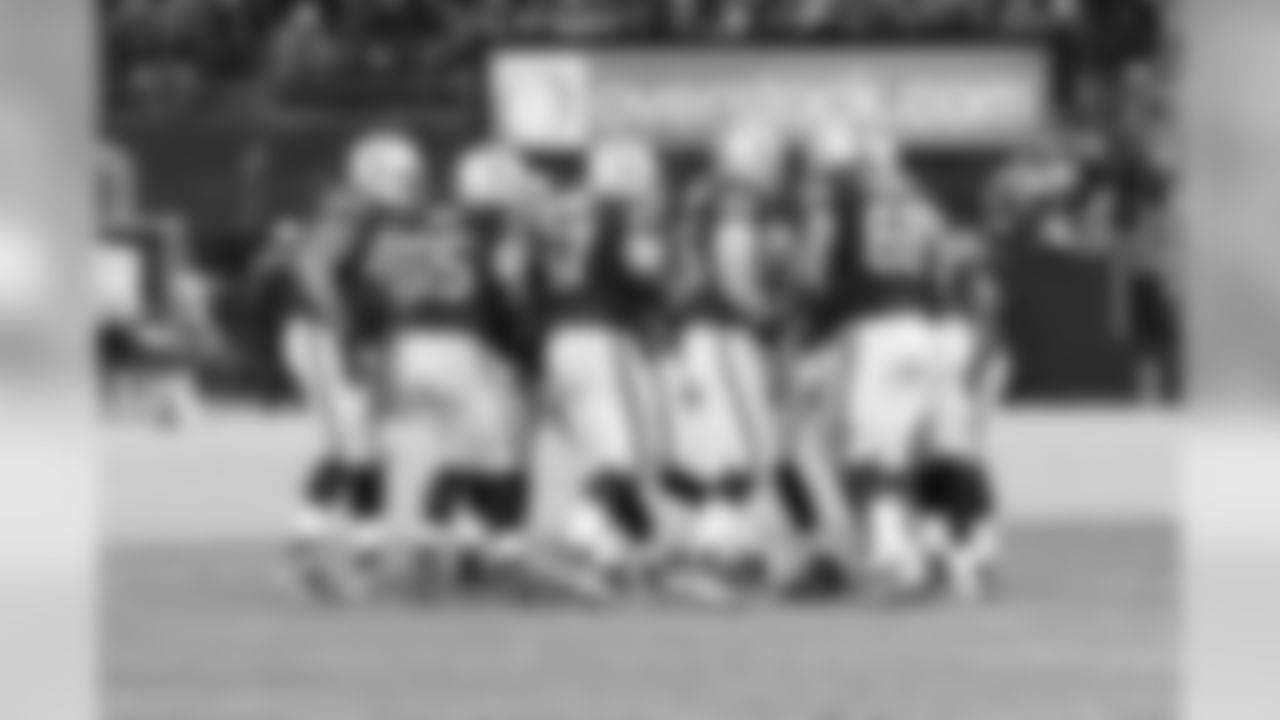 The Raiders offense gets the play call from QB Carson Palmer before breaking the huddle.