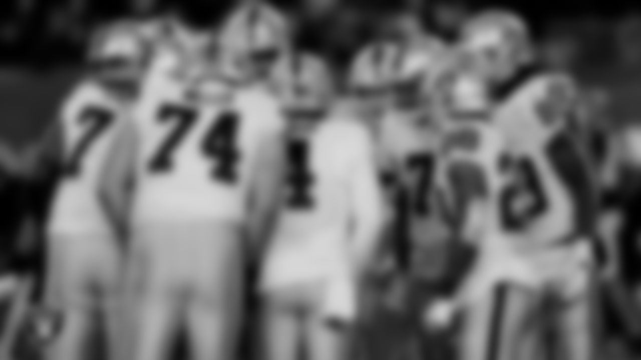 The Las Vegas Raiders offense huddles during the postseason away game against the Cincinnati Bengals.