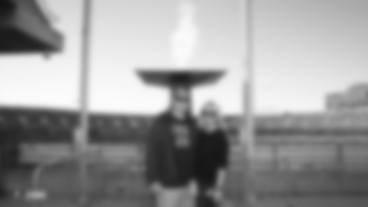 Raiders alumnus Sebastian Janikowski poses for a photo with his wife Lori Janikowski after lighting the Al Davis torch before the Raiders regular season game against the Cincinnati Bengals.
