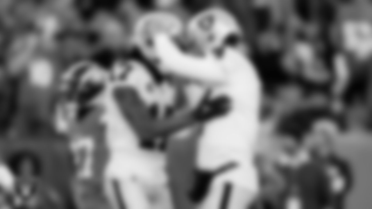 Las Vegas Raiders wide receiver Davante Adams (17) celebrates with quarterback Derek Carr (4) after making a 31-yard touchdown catch during the regular season away game against the Denver Broncos at Empower Field at Mile High.