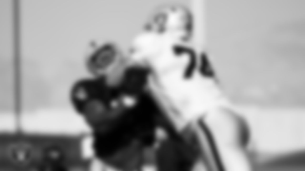 Las Vegas Raiders defensive end Yannick Ngakoue (91) and tackle Kolton Miller (74) on the field for practice at 2021 Training Camp.