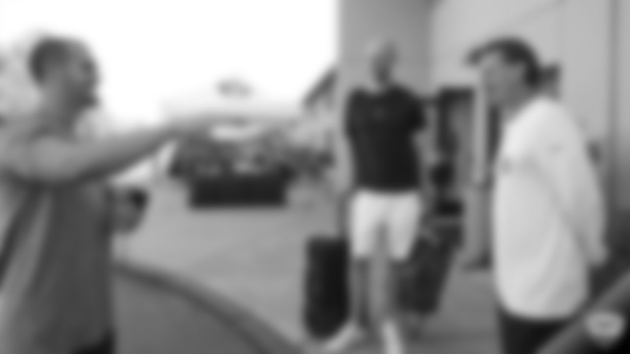 Oakland Raiders quarterback Derek Carr (4) and quarterback Mike Glennon (7) arrive for 2019 Training Camp and greet offensive coordinator Greg Olson.