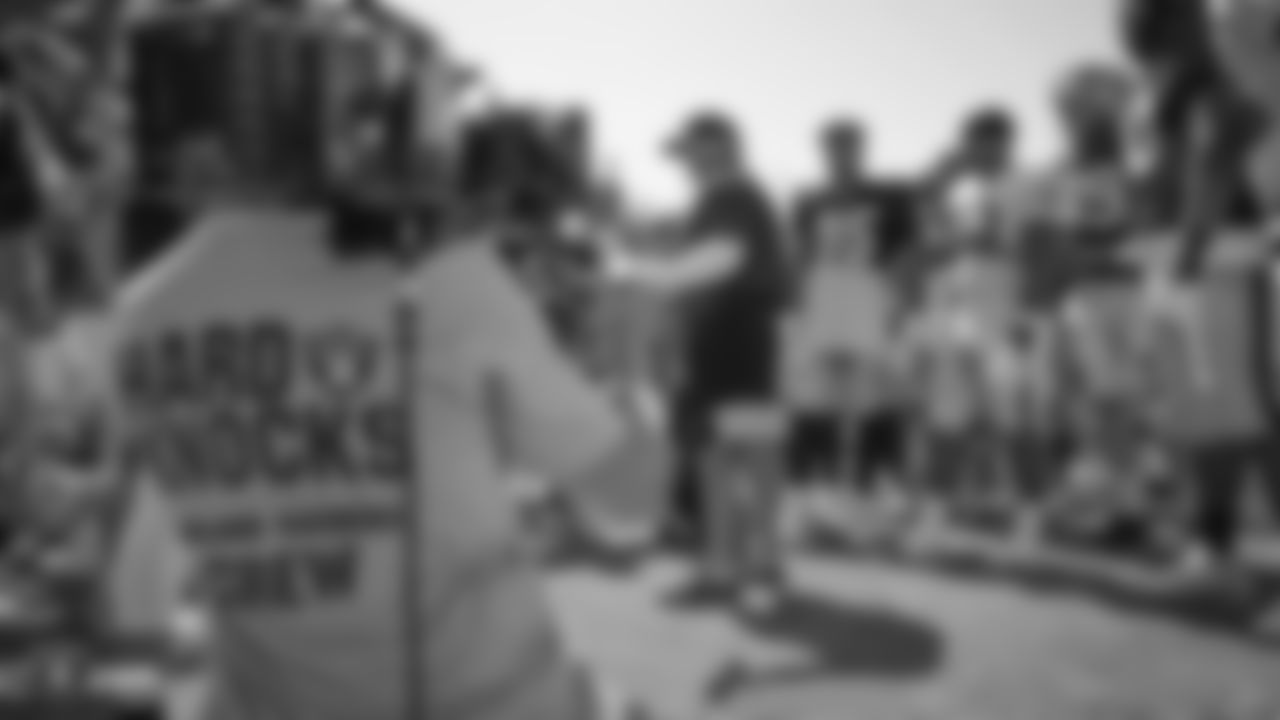 The Hard Knocks film crew in a team huddle on the field for practice at 2019 Training Camp.