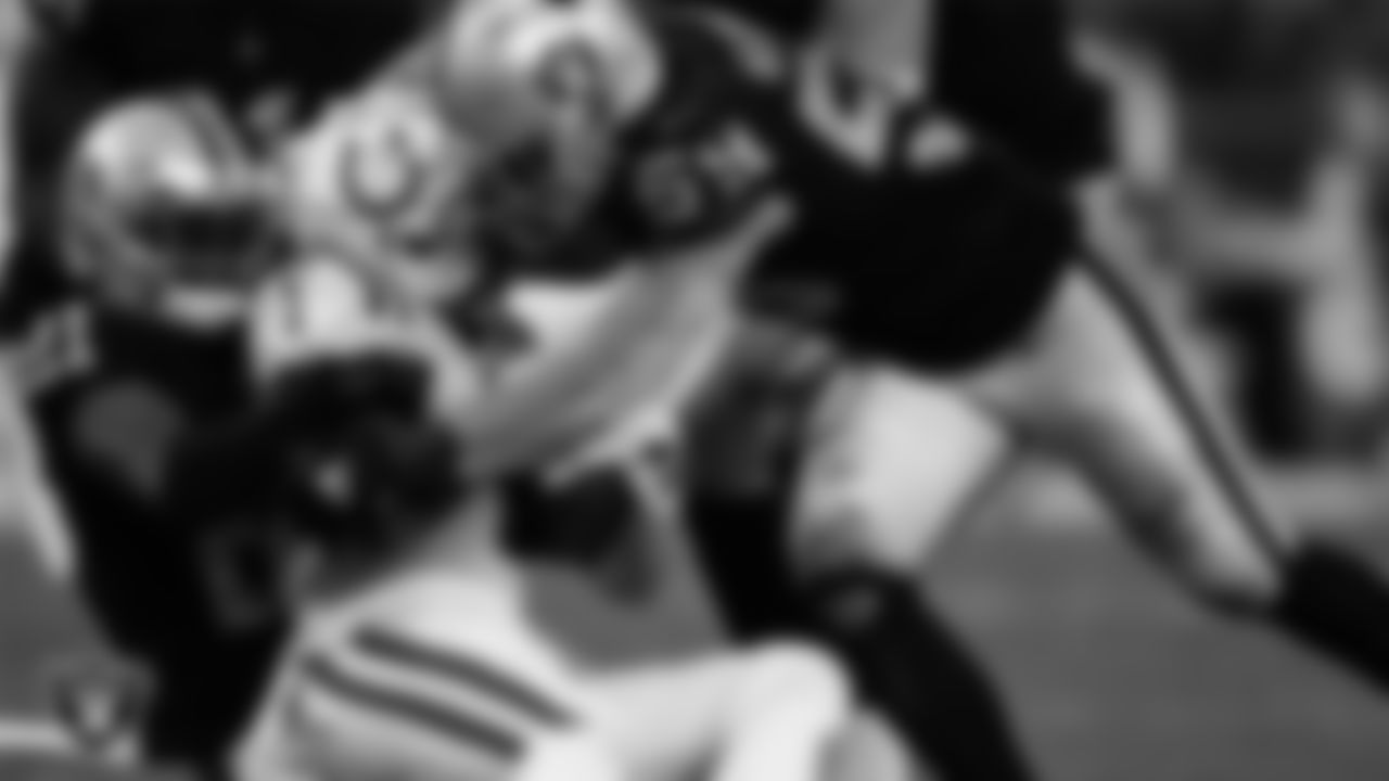 Las Vegas Raiders cornerback Amik Robertson (21) and linebacker Luke Masterson (59) make a tackle during the regular season home game against the Indianapolis Colts at Allegiant Stadium.
