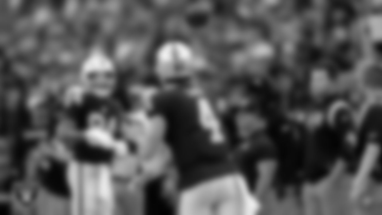 Las Vegas Raiders quarterback Derek Carr (4) warms up on the sidelines during the regular season home game against the Denver Broncos at Allegiant Stadium.