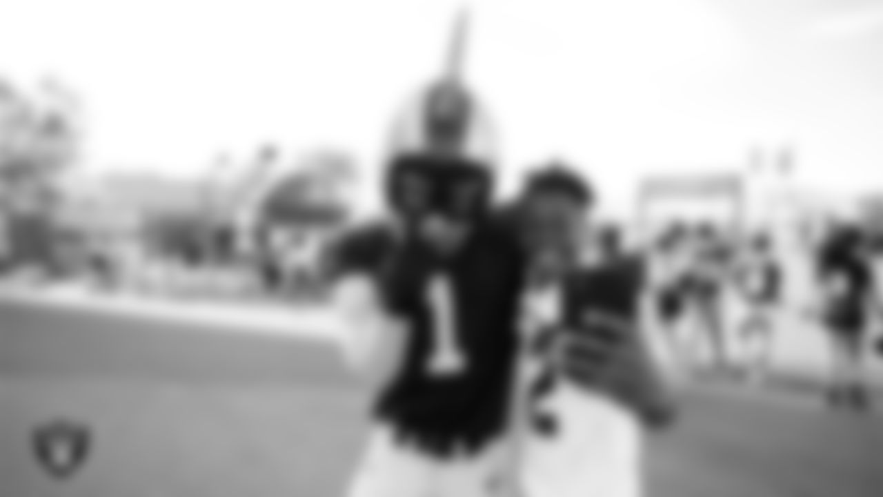 Raider Rusher poses for a selfie with a Spring Valley High School football player before practice at 2023 Training Camp at Intermountain Health Performance Center.