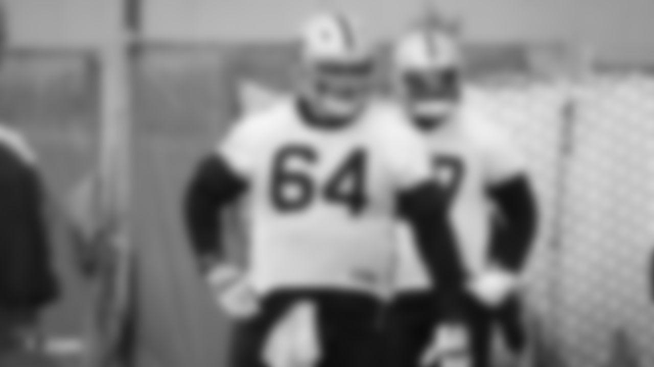 Raiders guard Richie Incognito (64) stands on the field during practice.