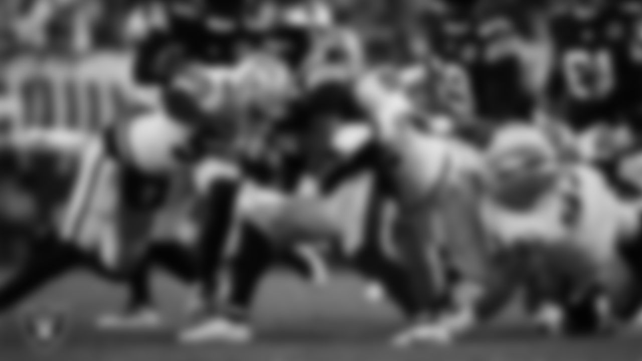 Las Vegas Raiders defensive end Chandler Jones (55) and defensive lineman Neil Farrell Jr. (92) make a tackle during the regular season away game against the Pittsburgh Steelers at Acrisure Stadium.