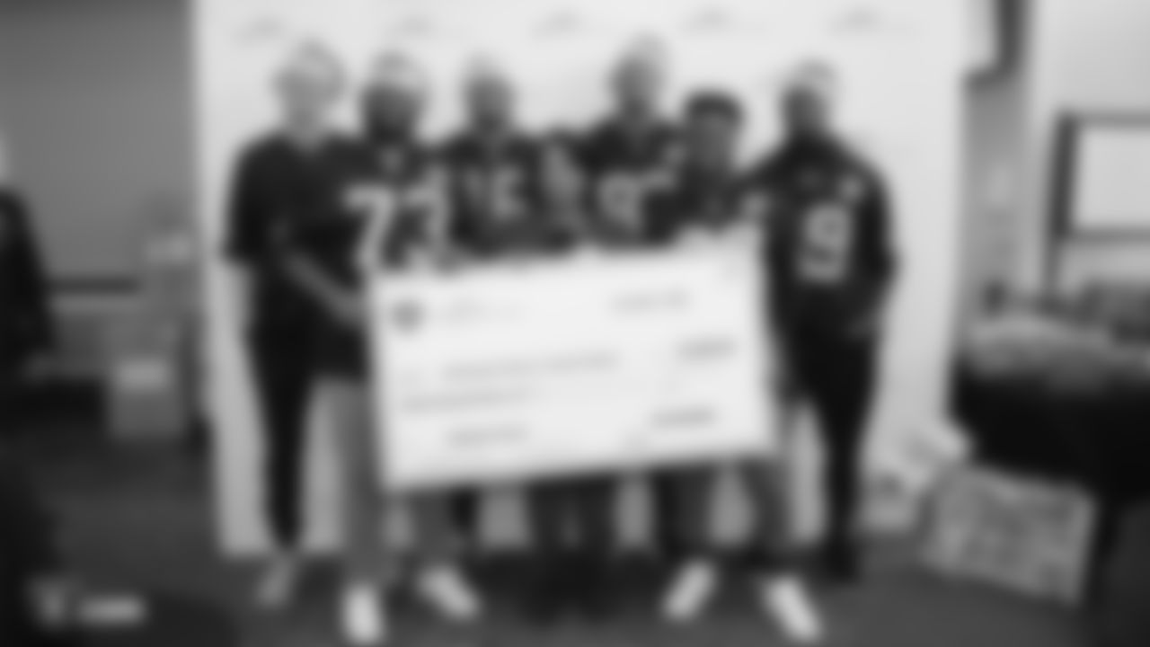 Raiders kicker Daniel Carlson (8), defensive tackle Maurice Hurst (73), wide receiver Tyrell Williams (16), tight end Darren Waller (83), running back James Butler (36) and linebacker Tahir Whitehead (59) present a check donation to UCSF Benioff Children's Hospital OaklandÕs director of volunteer services Darlene Wilson during their visit to the hospital.