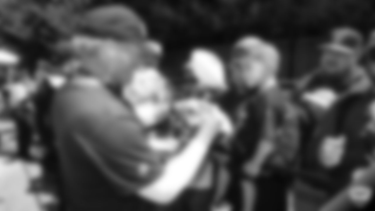 Raiders head coach Jon Gruden signs autographs for fans after practice at 2019 Training Camp.