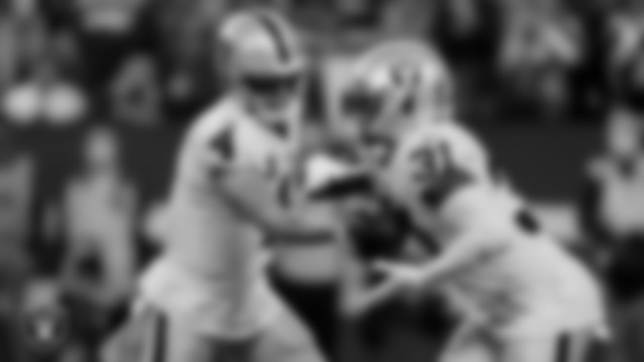 Las Vegas Raiders quarterback Derek Carr (4) and running back Peyton Barber (31) during the regular season away game against the Indianapolis Colts.
