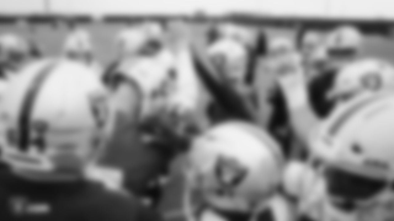 The Raiders huddle during practice.