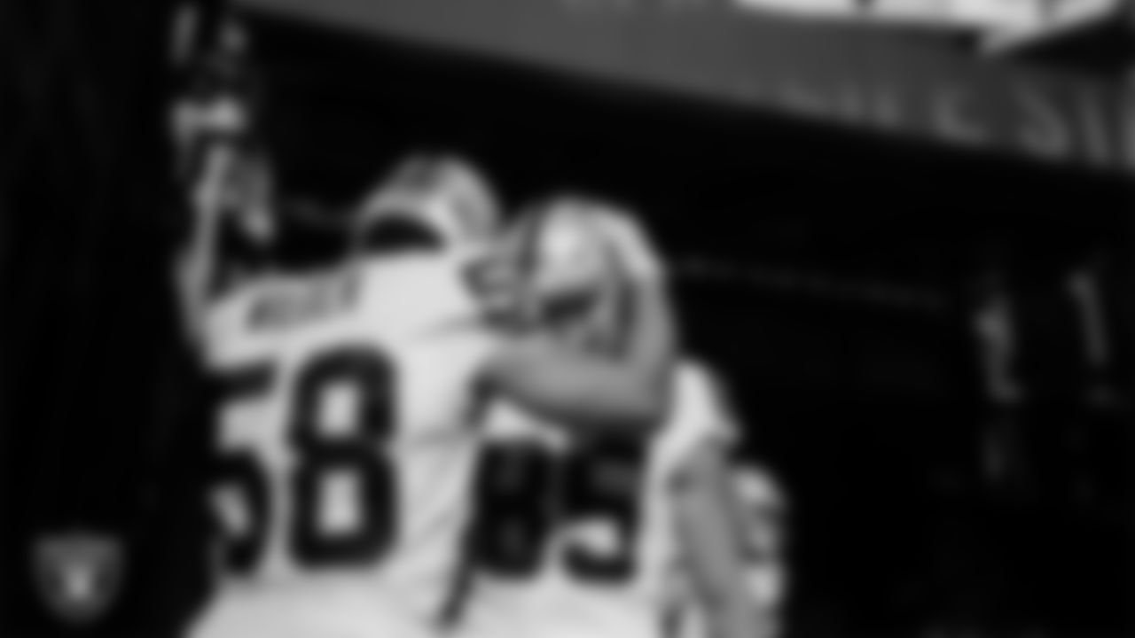 Las Vegas Raiders linebacker Kyle Wilber (58) and tight end Derek Carrier (85) wait to be introduced onto the field before the regular season away game against the New York Jets.