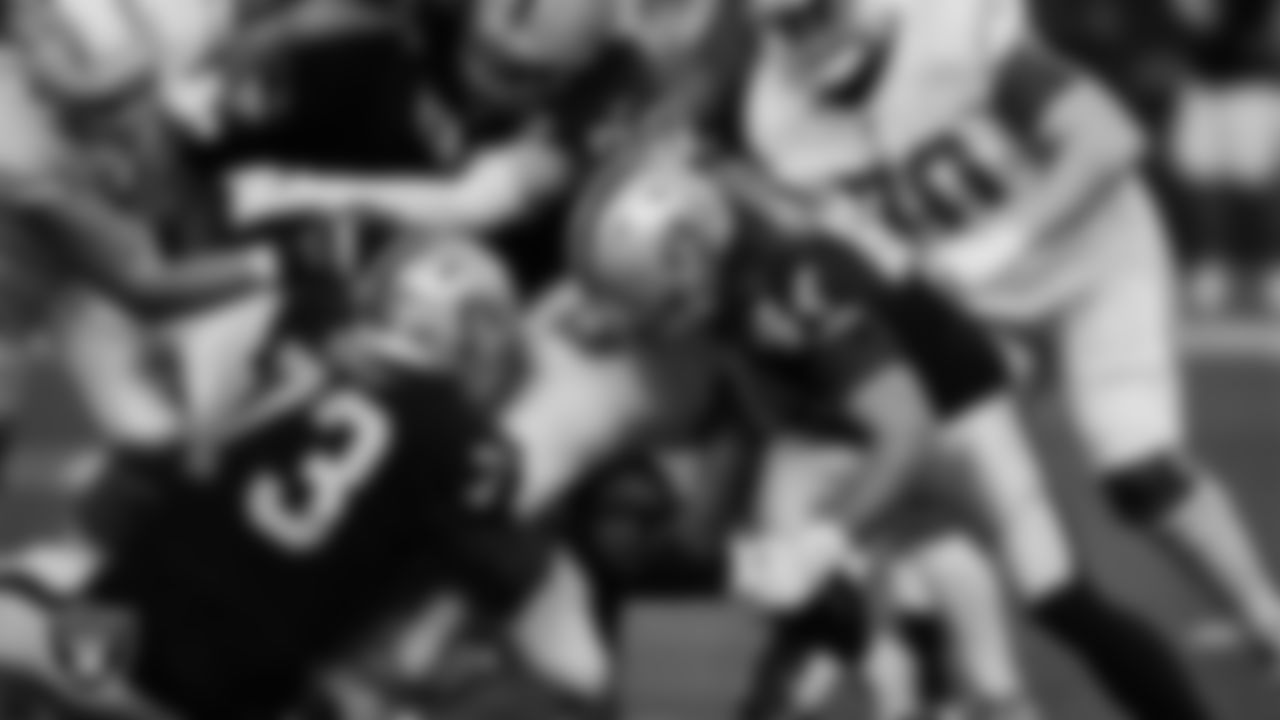 Las Vegas Raiders defensive tackle Maurice Hurst (73), defensive end Maxx Crosby (98) and linebacker Nick Kwiatkoski (44) make a tackle during the regular season home game against the Los Angeles Chargers.