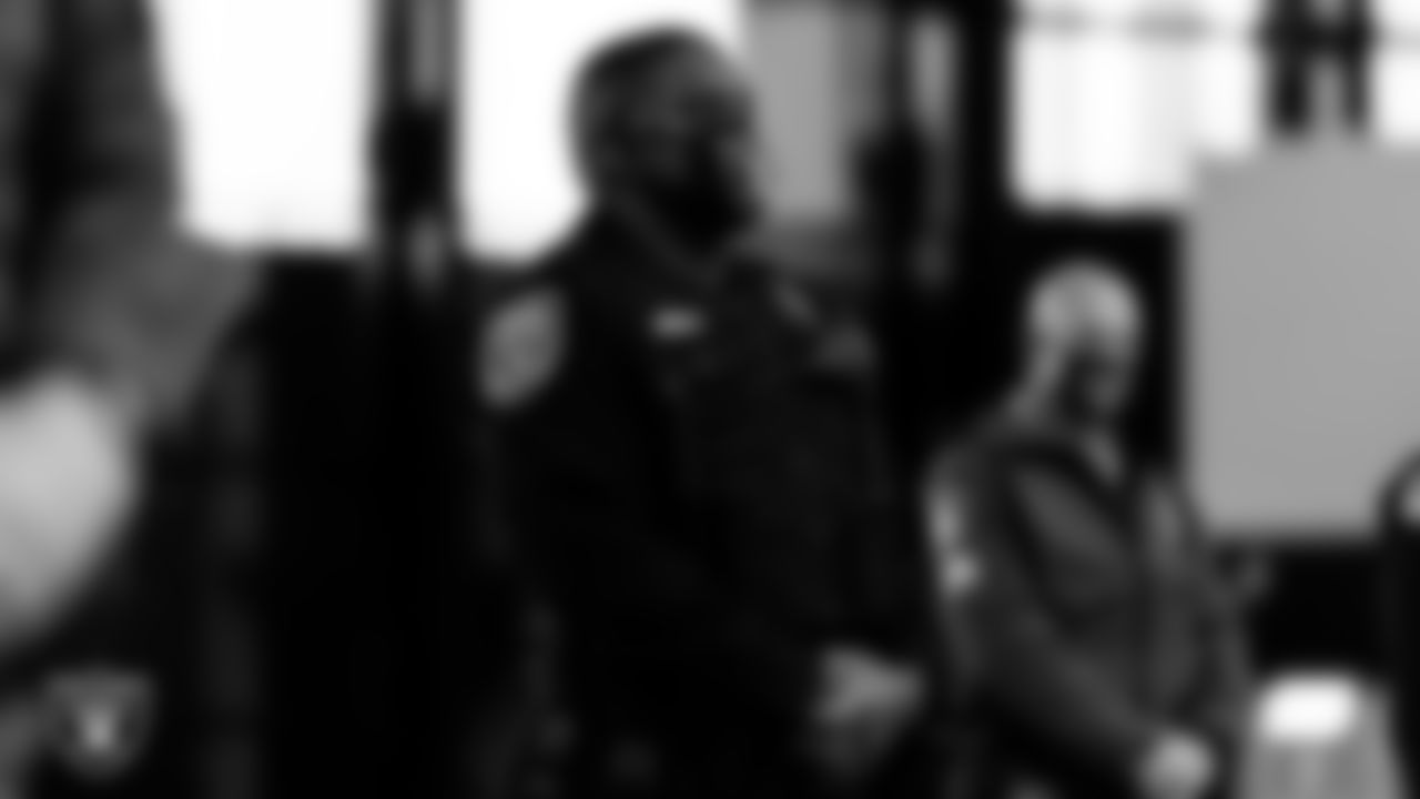 A member of the North Las Vegas Police Department waits to light the Al Davis Memorial Torch before the Las Vegas Raiders regular season home game against the Indianapolis Colts.