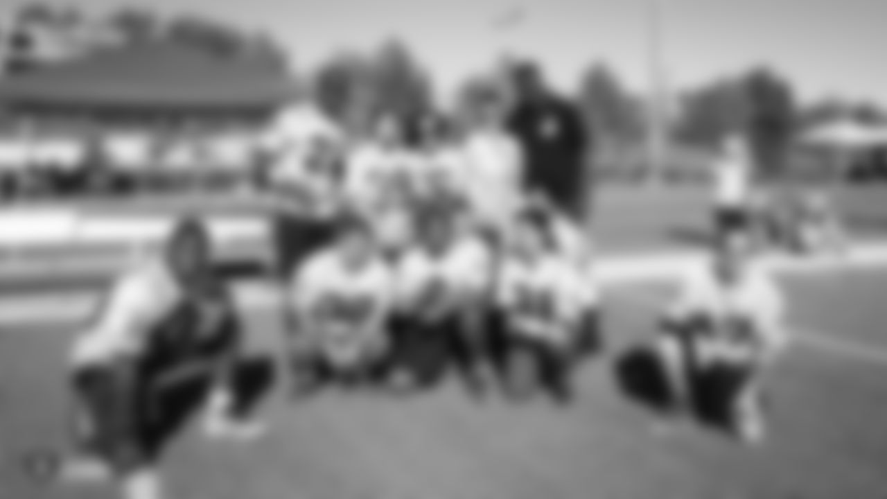 Raiders alumnus Isaiah Ekejiuba poses for a photo with athletes at a flag football tournament hosted by the Raiders and Special Olympics Nevada.