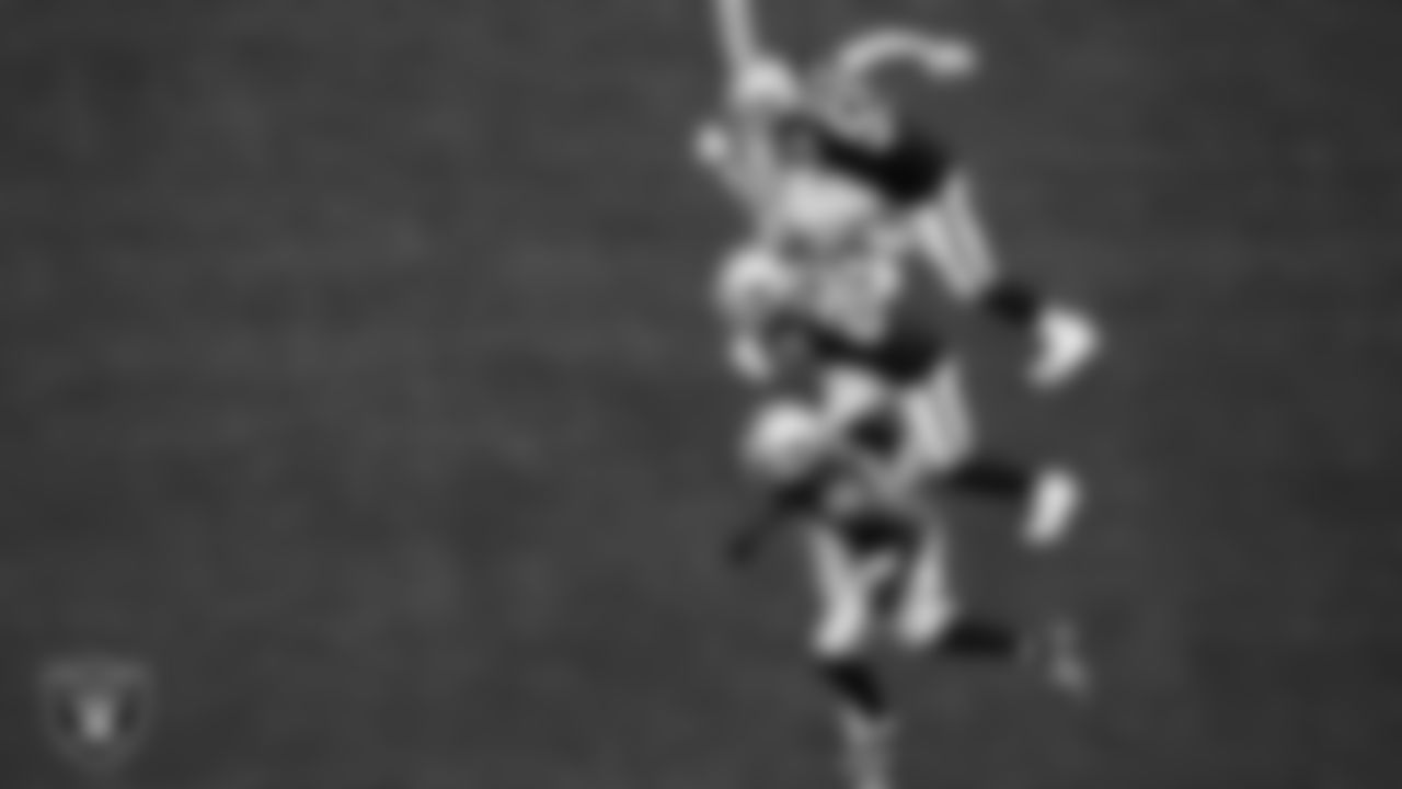 Las Vegas Raiders linebacker Luke Masterson (59), safety Isaiah Pola-Mao (20) and defensive end Clelin Ferrell (99) head down field after a kickoff during the regular season home game against the Arizona Cardinals at Allegiant Stadium.