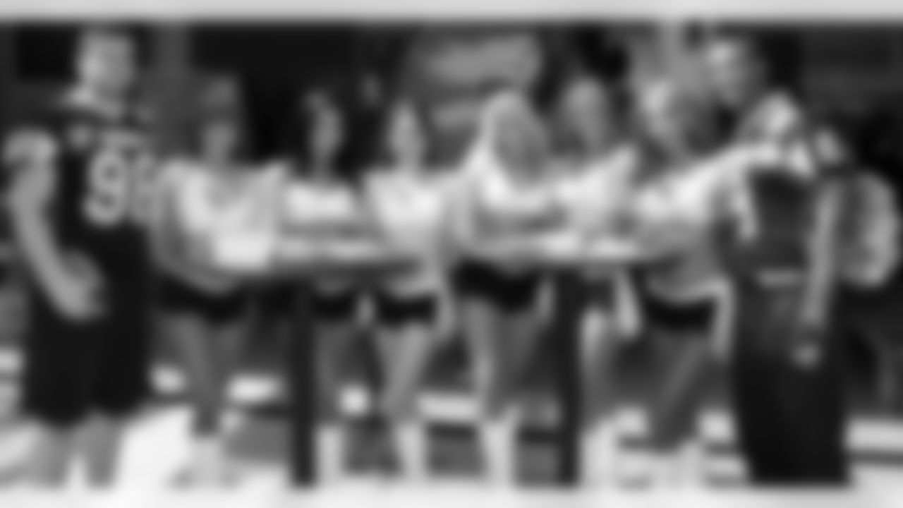 The six Raiderettes pose for a photo with their SWARCO Raiders hosts. Photo by Schellhorn.