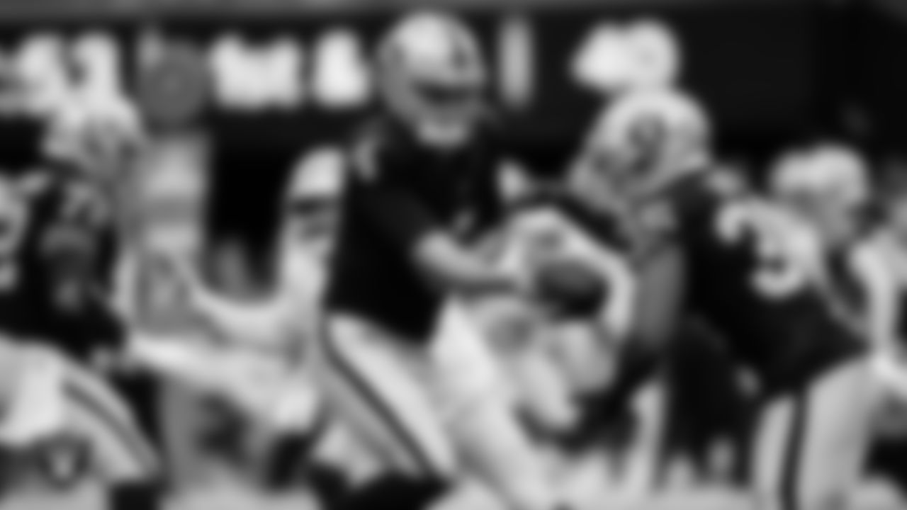 Las Vegas Raiders quarterback Aidan O'Connell (4) hands the ball off to running back Zamir White (35) during the preseason home game against the San Francisco 49ers at Allegiant Stadium.