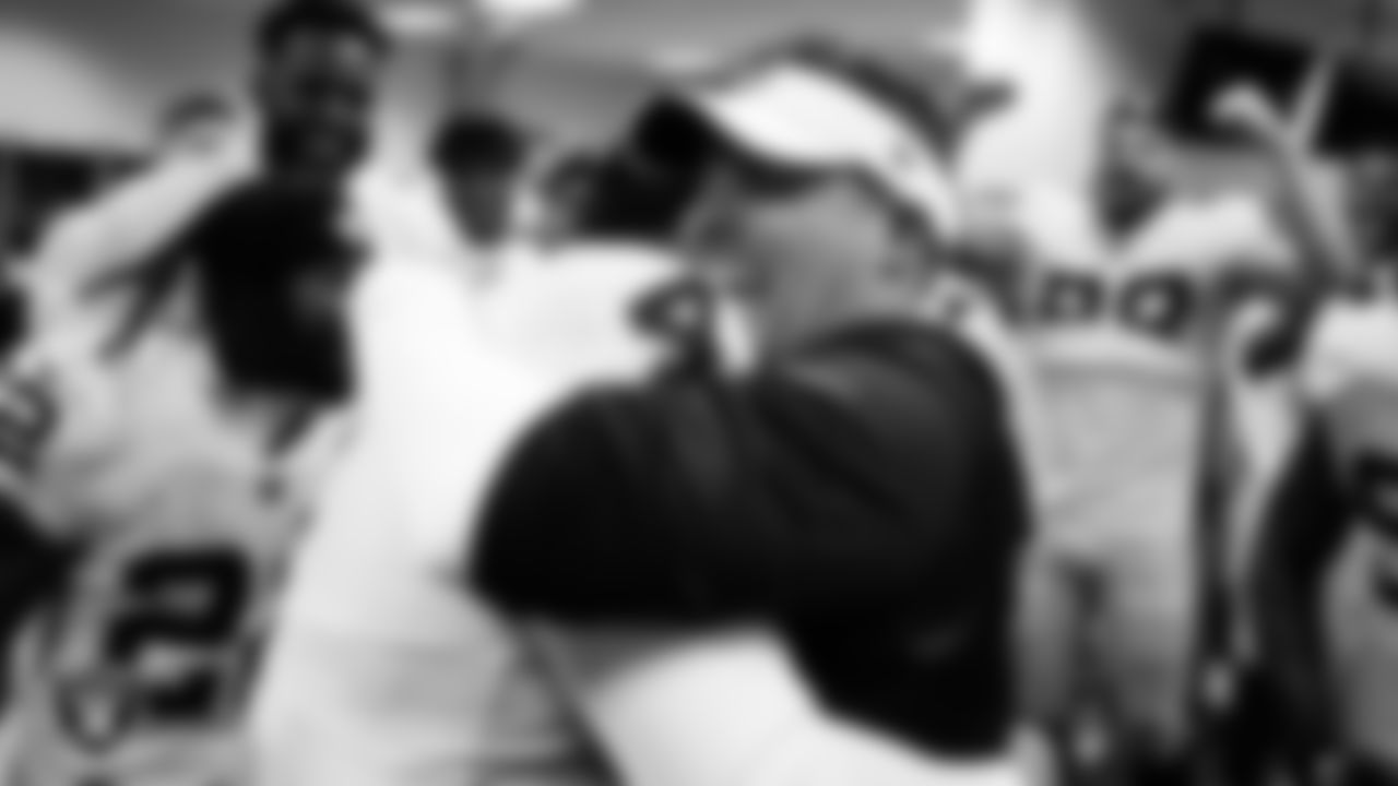 Las Vegas Raiders quarterback Derek Carr (4) and Head Coach Josh McDaniels in the locker room after the regular season away game against the Denver Broncos at Empower Field at Mile High.