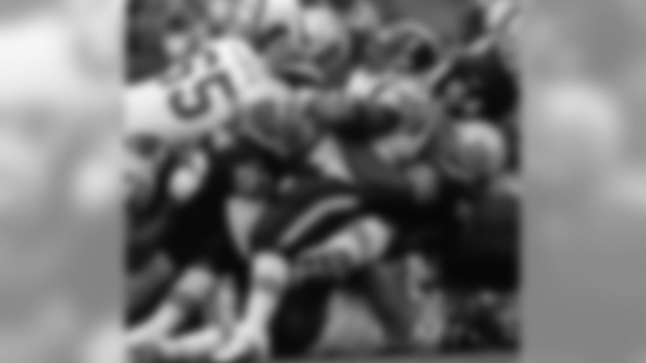 James Harris and Darrell Russell take down the San Diego ball carrier in a 1999 contest.