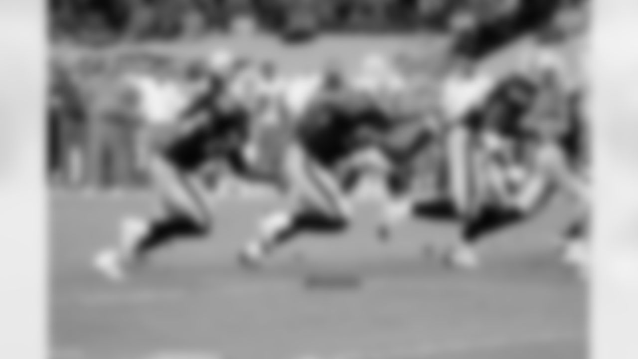 S Usama Young, LB Khalil Mack and DT Antonio Smith get off the ball.
