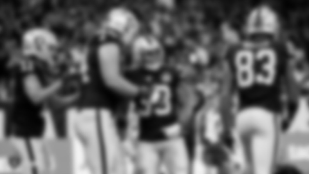 Raiders tackle Kolton Miller (74) and running back DeAndré Washington (33) celebrate after rushing for a 3-yard touchdown during the game against the Chicago Bears at Tottenham Hotspur Stadium.