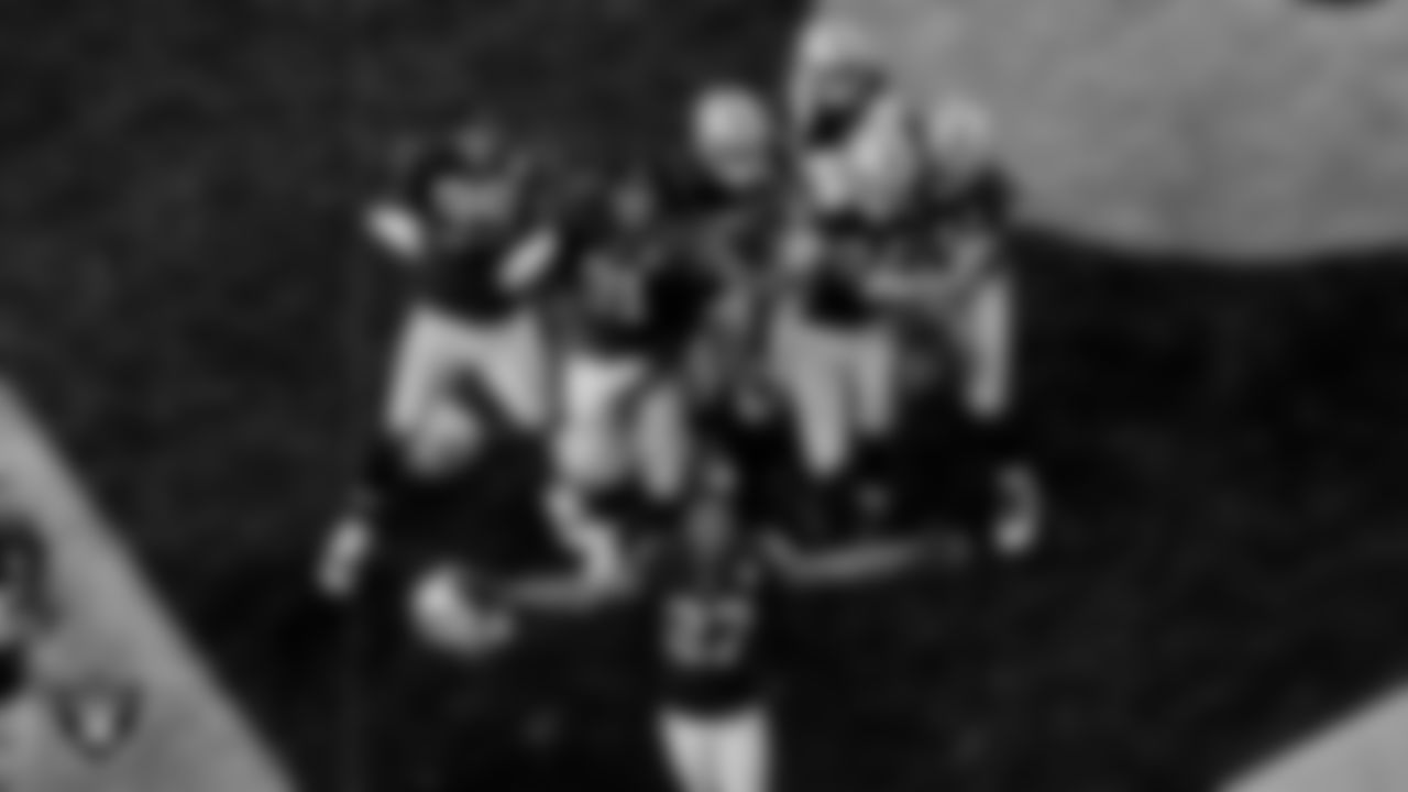 Las Vegas Raiders defensive end Carl Nassib (94) is congratulated by teammates after an interception during the regular season game against the Denver Broncos at Allegiant Stadium.