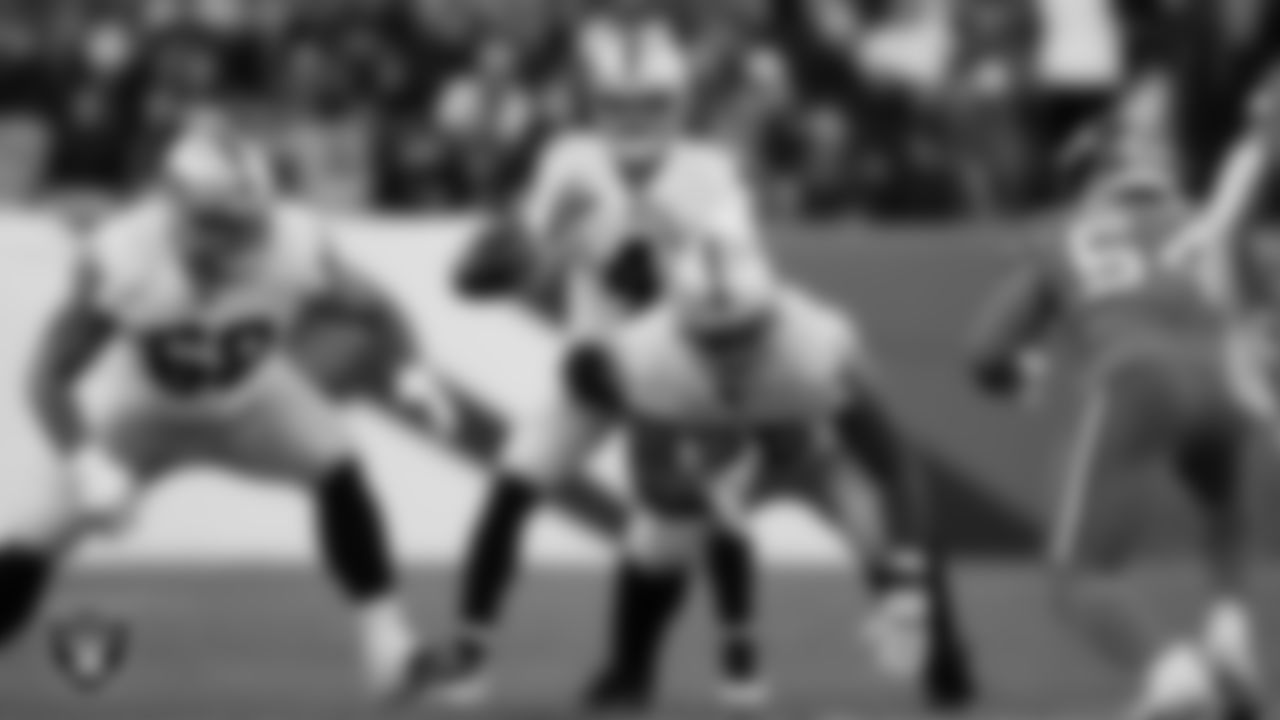 Las Vegas Raiders quarterback Derek Carr (4) receives the snap during the regular season away game against the Denver Broncos at Empower Field at Mile High.