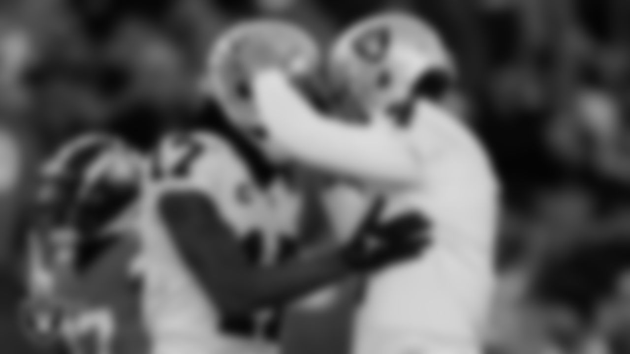 Las Vegas Raiders wide receiver Davante Adams (17) and quarterback Derek Carr (4) celebrate after connecting on a 31-yrad touchdown catch during the regular season away game against the Denver Broncos at Empower Field at Mile High.