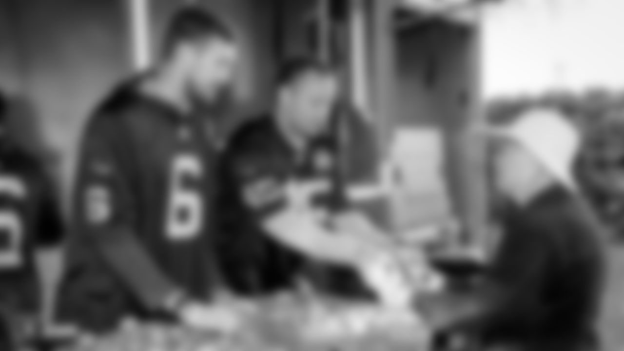 Raiders fullback Alec Ingold (45) hands out pears at the Alameda County Community Food Bank Mobile Pantry to sort and distribute food to low-income families.