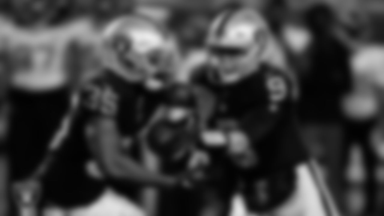 Las Vegas Raiders running back Zamir White (35) and quarterback Nick Mullens (9) during the Hall of Fame Game against the Jacksonville Jaguars at Tom Benson Hall of Fame Stadium.