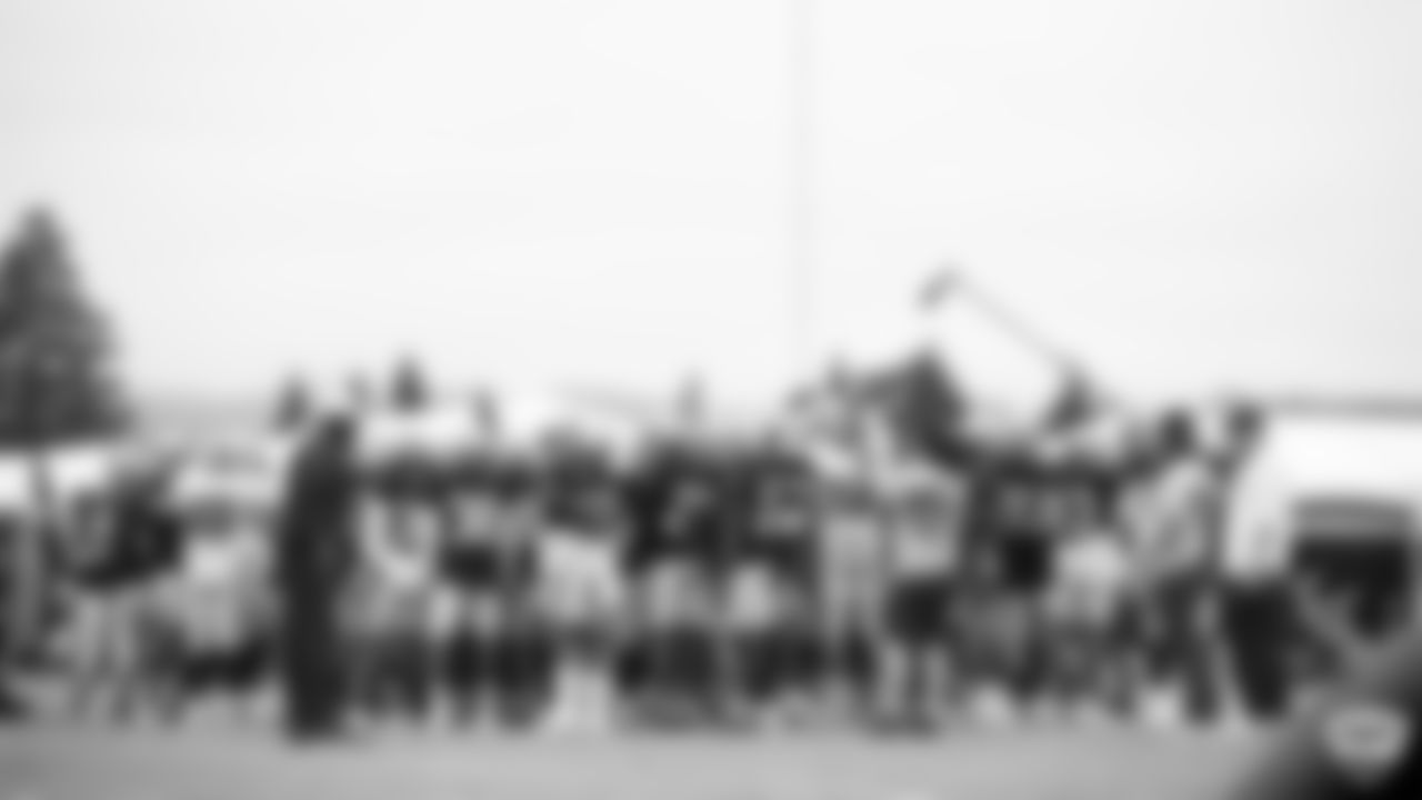 The Raiders huddle up on the field during practice at 2019 Training camp.