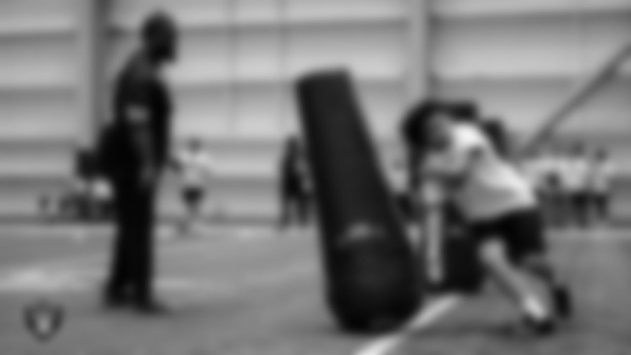 Las Vegas Raiders defensive lineman Neil Farrell Jr. (92) works with an athlete as they participate in drills during the ELITE Academy at Las Vegas Raiders Headquarters.