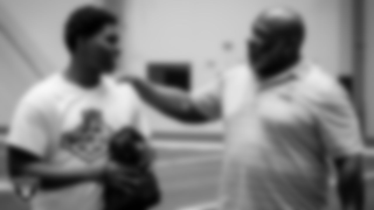 Las Vegas Raiders alumnus Roy Hart presents his top performer with some Raiders gear during the ELITE Academy at the Las Vegas Raiders Headquarters.