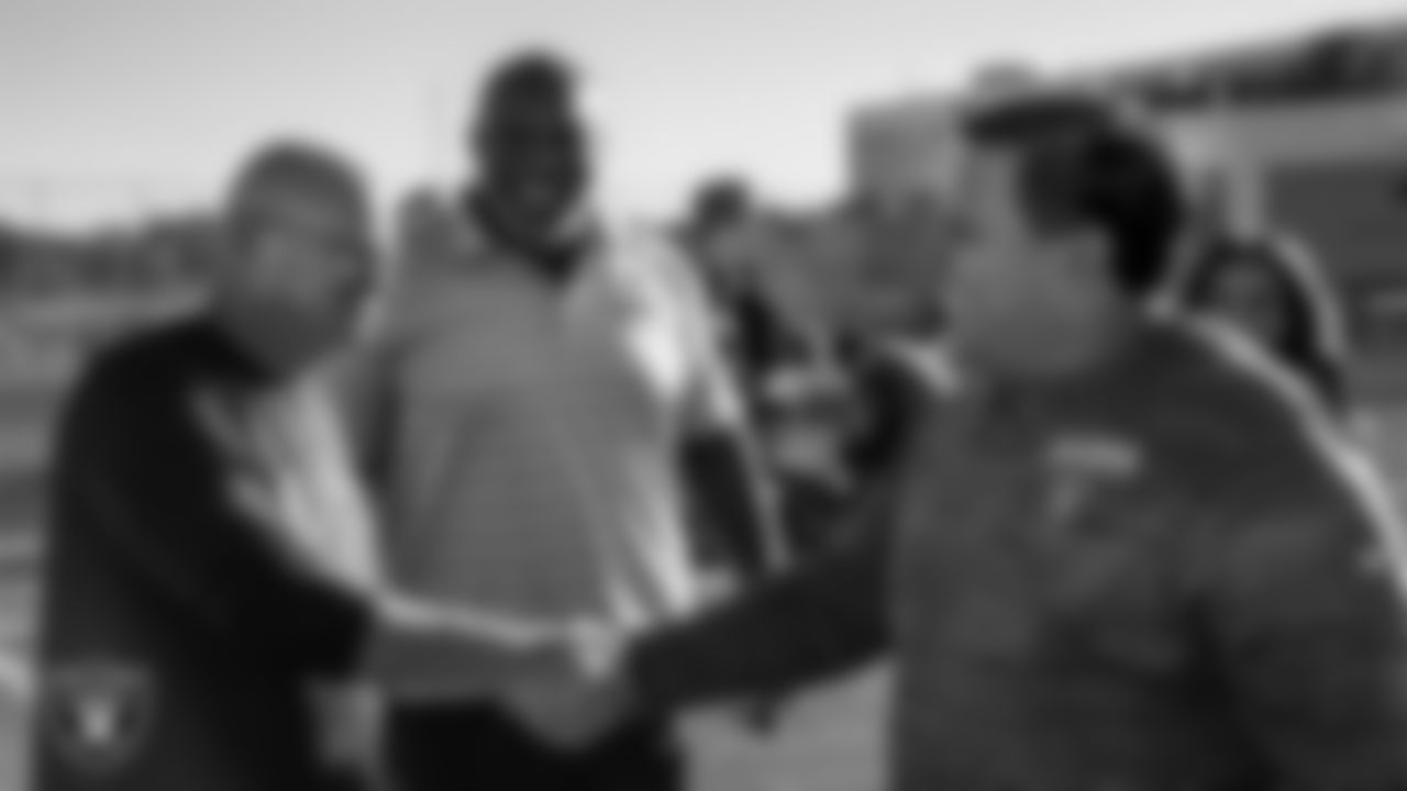 Las Vegas Raiders youth football manager Jordan Aguilar shakes hands with Chaparral High School's football coach Don Willis.
