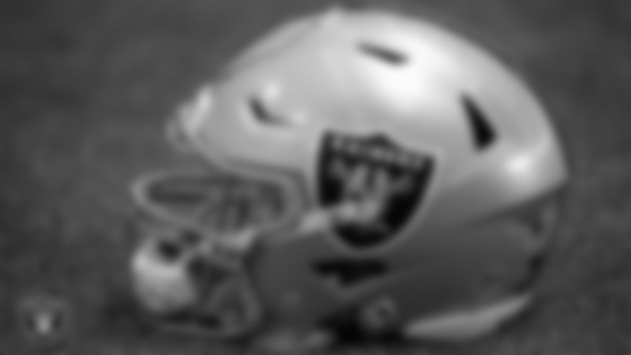A Las Vegas Raiders helmet on the field during practice.