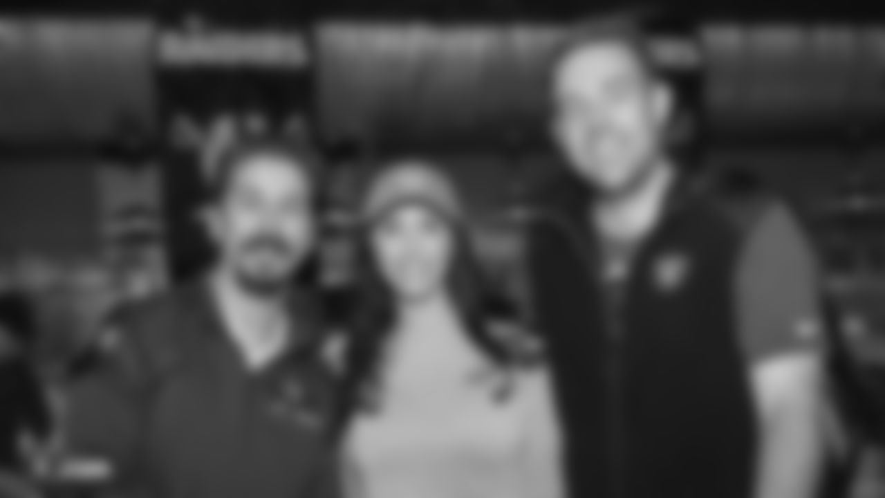 Attendees pose for a photo at a Watch Party for members of the Las Vegas Raiders Family Association, troops from Nellis Air Force Base and their families during the Raiders regular season game against the New York Jets.