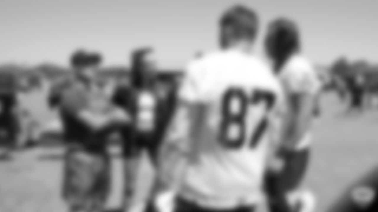 Musical artist Bohnes, model Josephine Skriver, tight end Foster Moreau (87), and tight end Luke Willson (82) after practice at 2019 Training Camp.