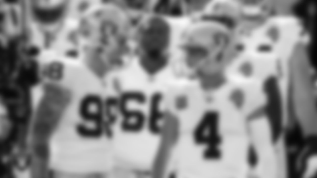 Las Vegas Raiders defensive end Maxx Crosby (98), guard Gabe Jackson (66) and quarterback Derek Carr (4) wait to be introduced onto the field before the regular season away game against the Kansas City Chiefs.