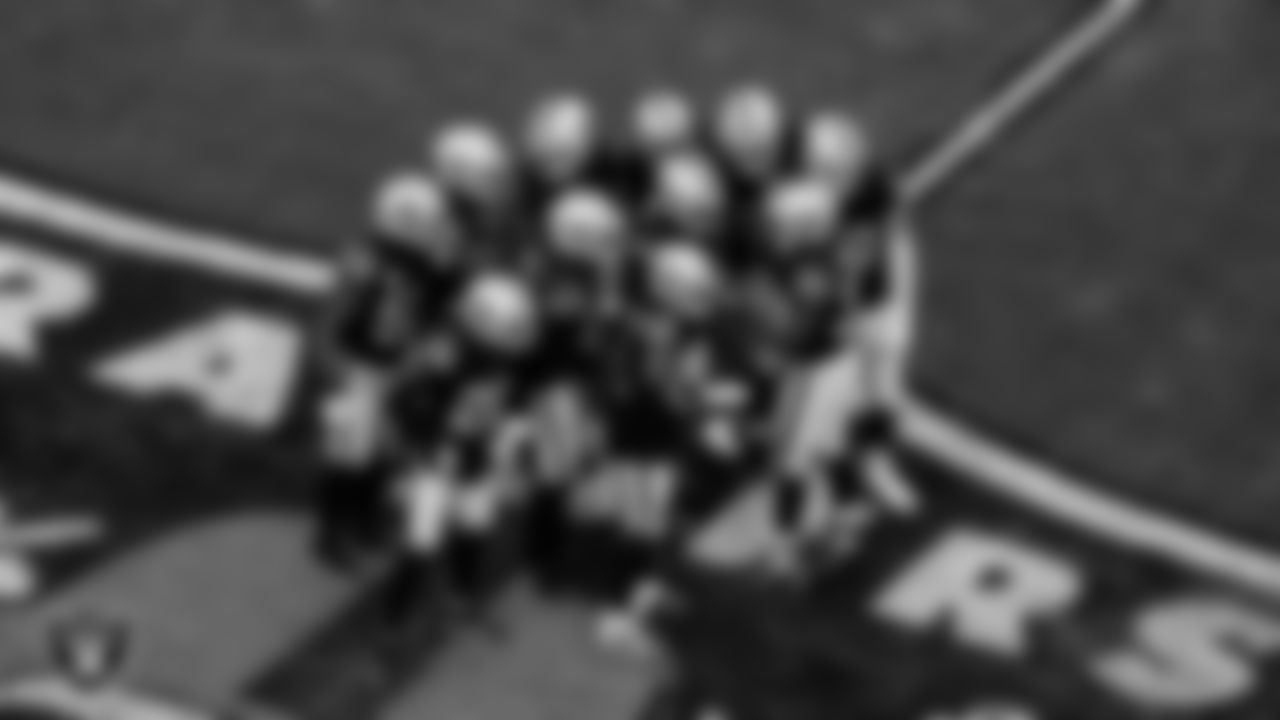 The Las Vegas Raiders defense huddle during the regular season home game against the Los Angeles Chargers at Allegiant Stadium.