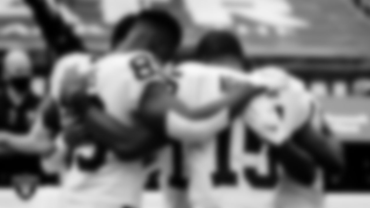 The Las Vegas Raiders wide receivers huddle on the sidelines before the regular season away game against the New England Patriots.