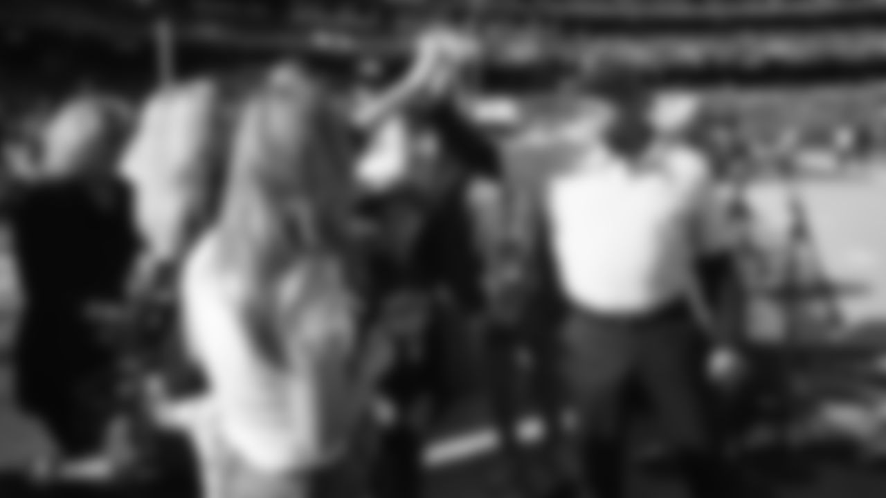 Raiders Head Coach Jon Gruden high fives fans before the regular season game against the Cincinnati Bengals.