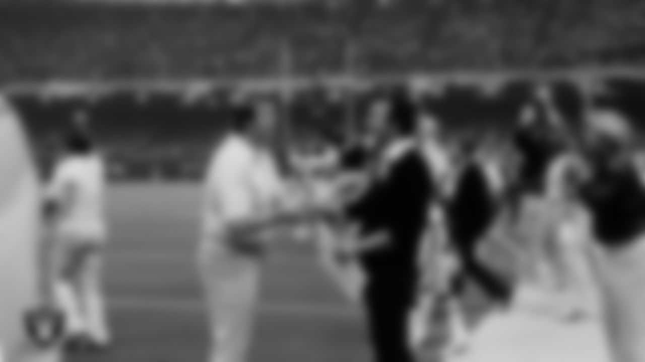 Oakland Raiders Head Coach Tom Flores celebrates on the field after Super Bowl XV against the Philadelphia Eagles.