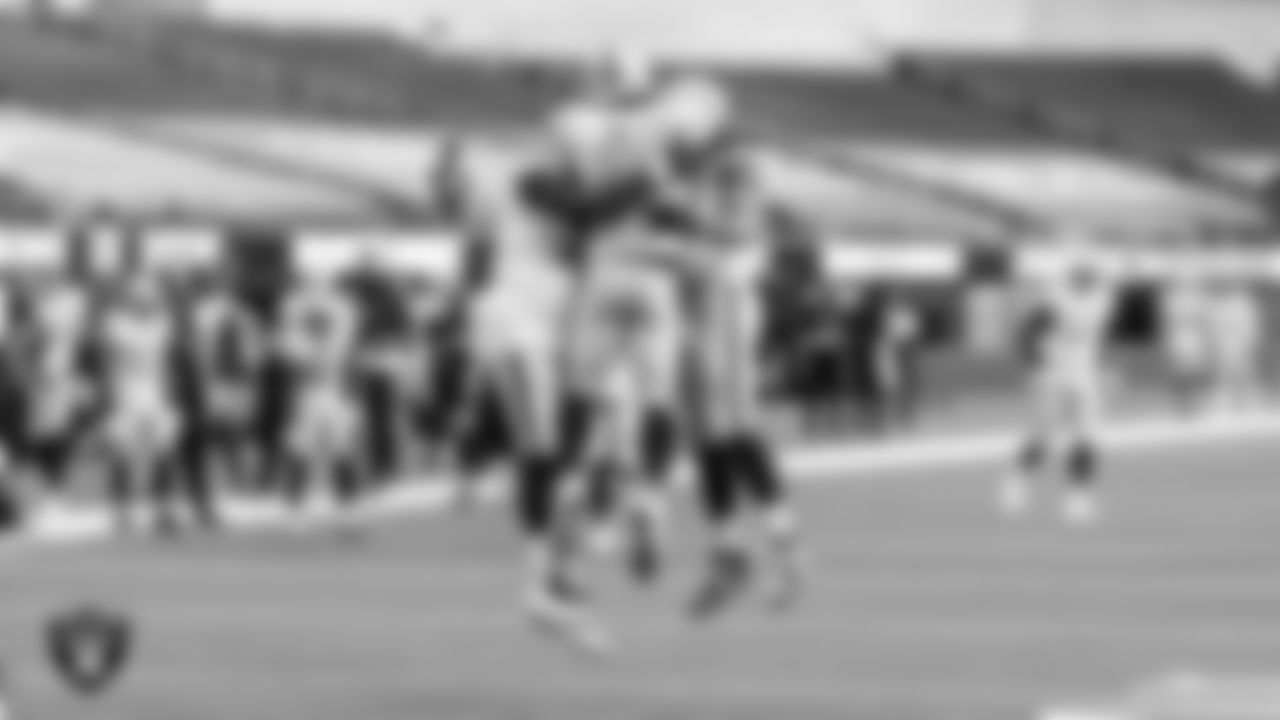 Las Vegas Raiders tight end Darren Waller (83) celebrates with offensive lineman Jaryd Jones-Smith (72) and tight end Foster Moreau (87) after making a 2-yard touchdown catch during the regular season away game against the Los Angeles Chargers.