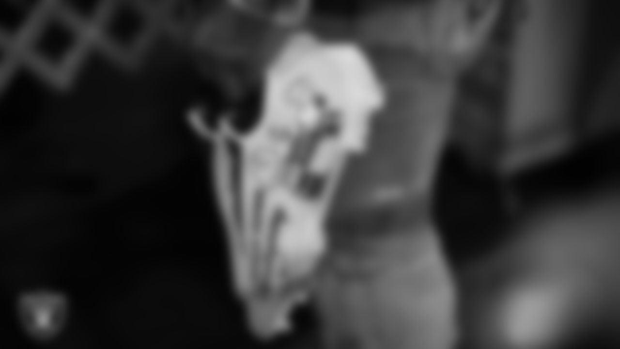 Las Vegas Raiders running back Josh Jacobs (28) holds a pair of Charlie Brown themed cleats as he arrives to the regular season away game against the Dallas Cowboys.