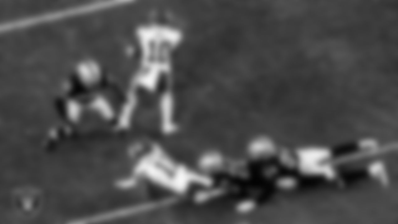 Las Vegas Raiders cornerback Damon Arnette (20) and safety Johnathan Abram (24) make a tackle during the regular season home game against the Kansas City Chiefs.
