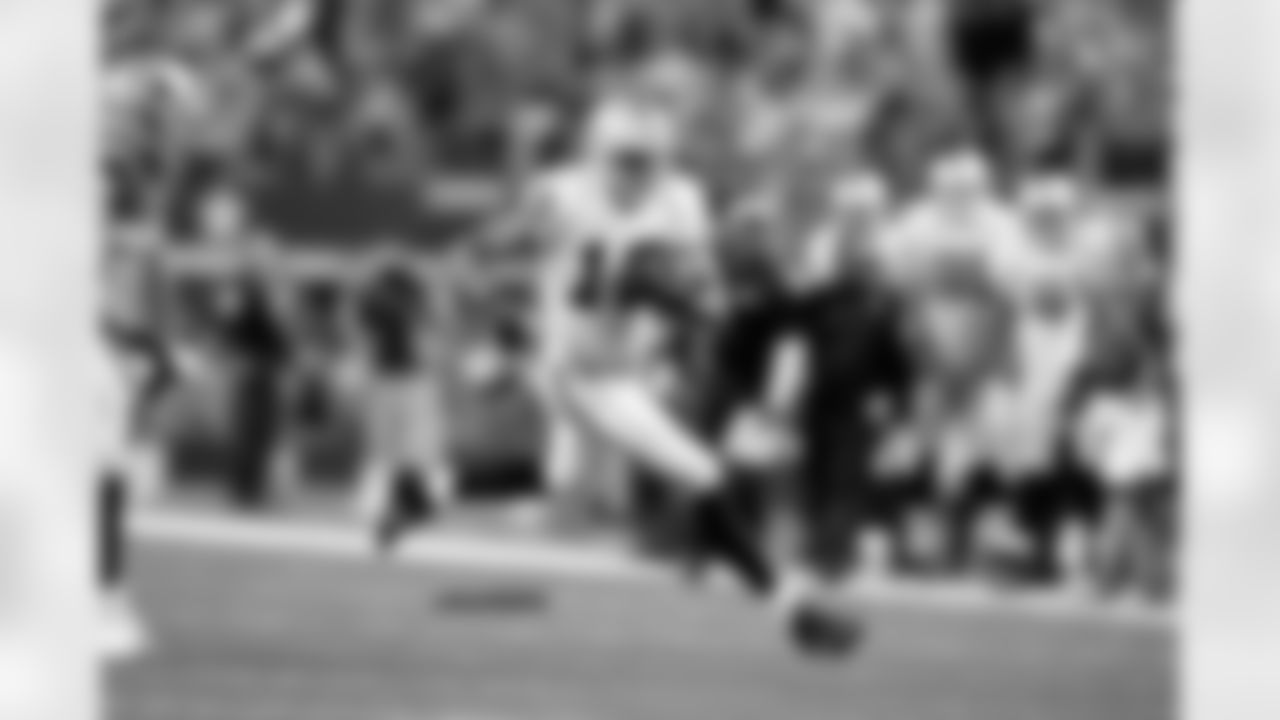 WR Andre Holmes races past the defenders for a substantial gain.